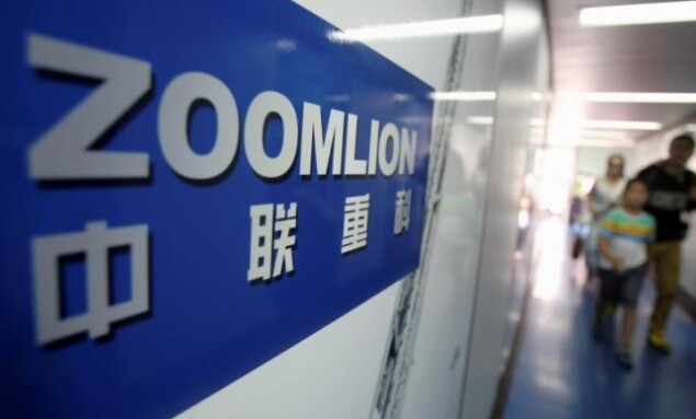 A Zoomlion company logo is seen on an advertisement as passengers walk past at an airport in Changsha