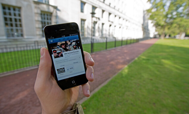 A_serviceman_accesses_social_media_channels_using_a_smart_phone,_outside_MOD_Main_Building_in_London_MOD_45156045
